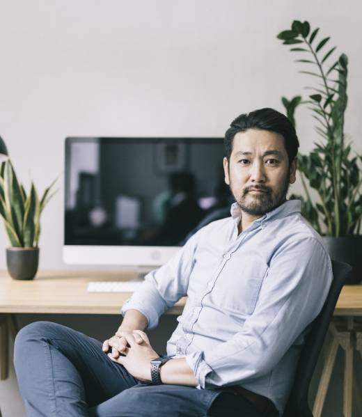 Formal portrait of confident Japanese entrepreneur.